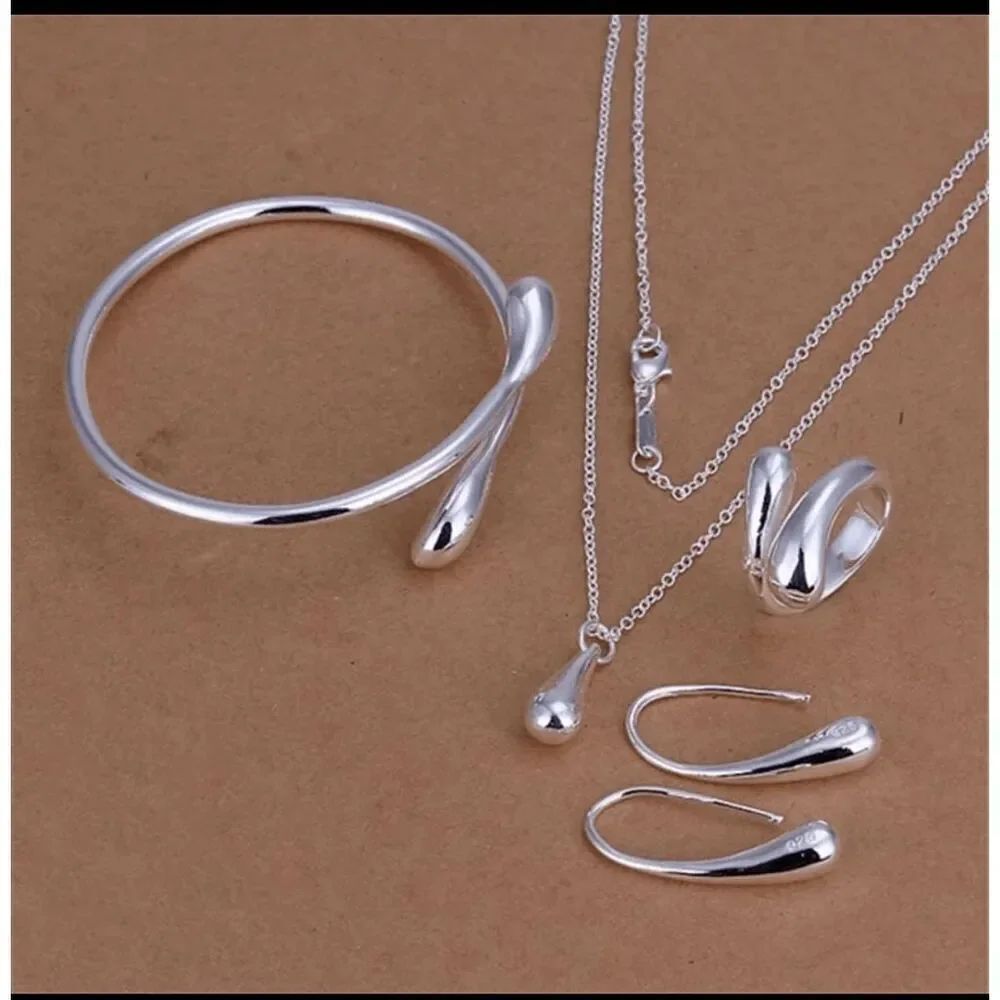 NWOT Silver Drop Jewelry Set of 4: Bracelet, Earrings, Rings, Necklace -Marked 9
